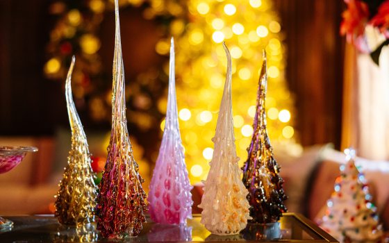 Five blown glass pieces resting on a table part of A Longwood Christmas. 